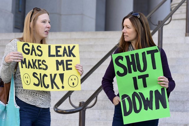 Porter Ranch residents hold signs outside Los Angeles City Hall during a demonst