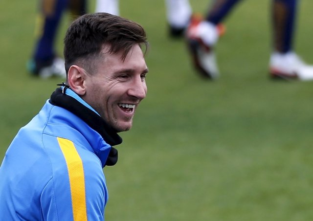 Barcelona's soccer player Messi smiles during a training session ahead of their 