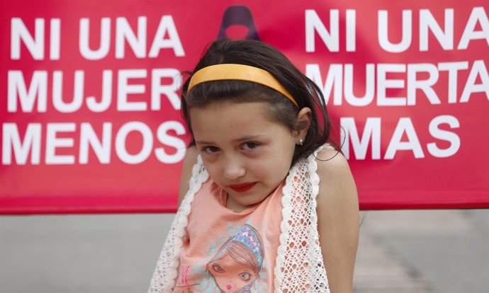 A child is seen during a march to commemorate International Day for the Eliminat