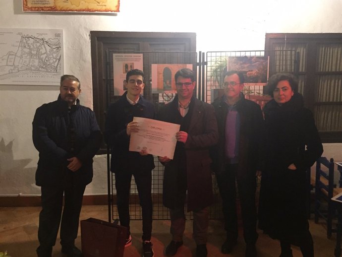 García (centro) entrega el premio al estudiante durante la inauguración