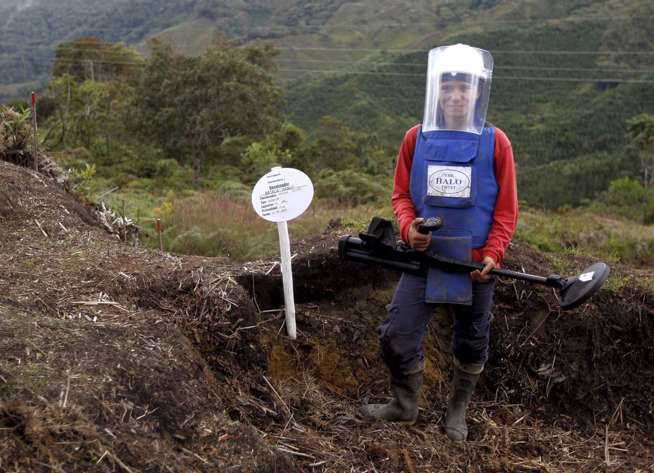 Natalia Arango poses with her mine detector in a zone of landmines planted by re