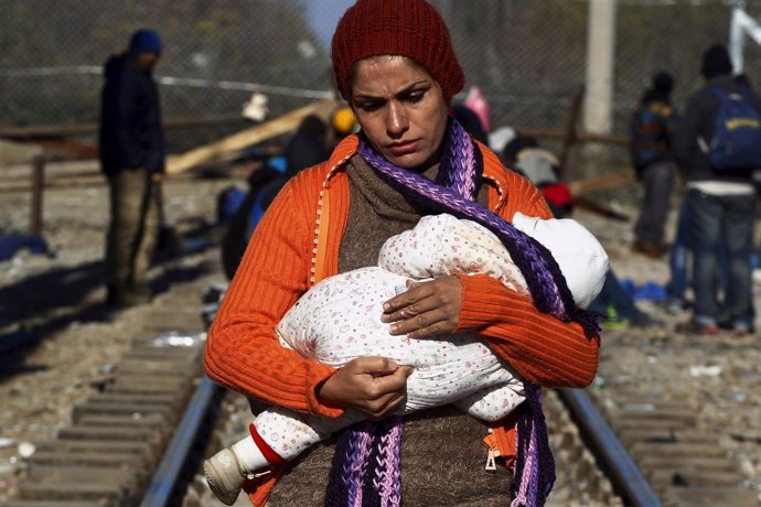 Mujer refugiada con un bebé en la frontera de Grecia y Macedonia