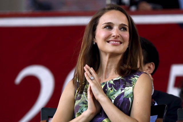 Actress Portman smiles on stage before addressing the Class of 2015 during Harva