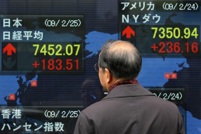 TOKYO - FEBRUARY 25:  A man looks at an electronic board displaying the current 