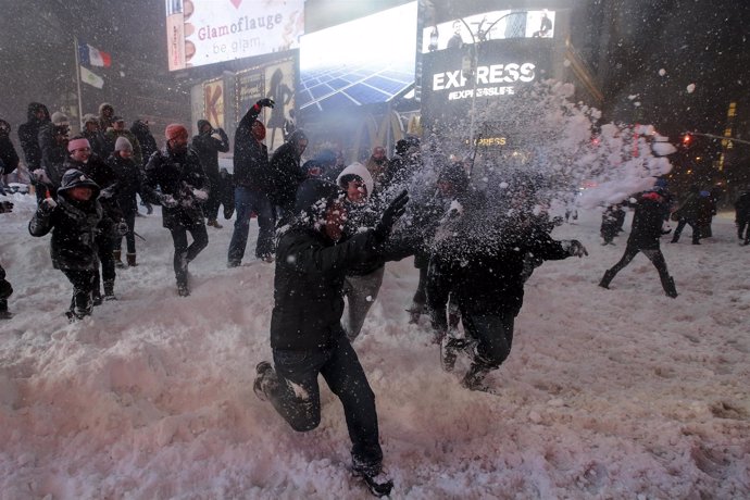 Dozens of people take part in an impromptu snow ball fight during a snow storm i