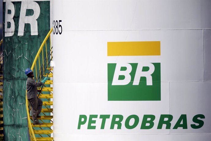 A worker paints a tank of Brazil's state-run Petrobras oil company in Brasilia