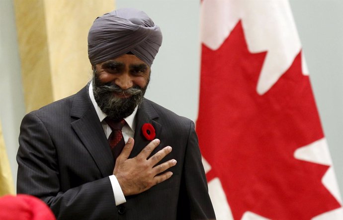 Canada's new National Defence Minister Harjit Sajjan gestures after being sworn-