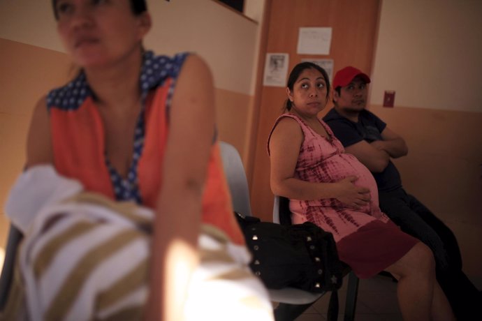 A pregnant woman waits to be attended to at the Women's National Hospital in San