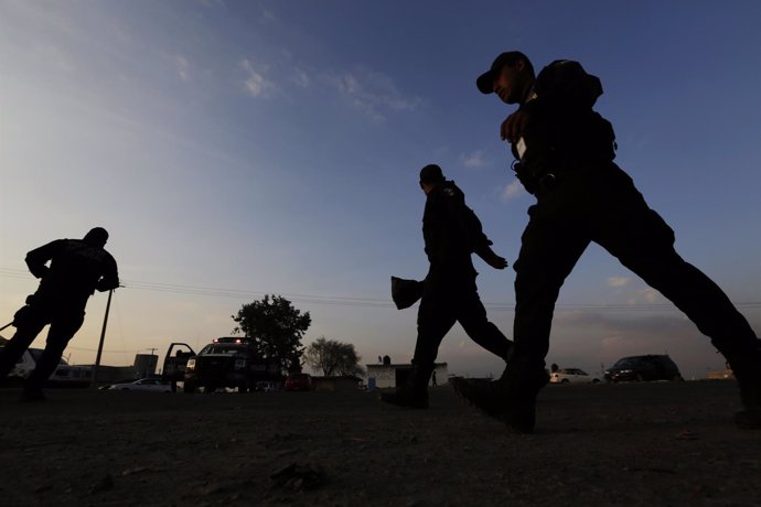 Federal police officers walk outside the Altiplano prison in Almoloya de Juarez