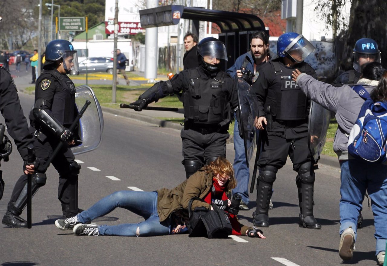 Photographer Maria Pirsch falls on the road after being hit by anti-riot policem