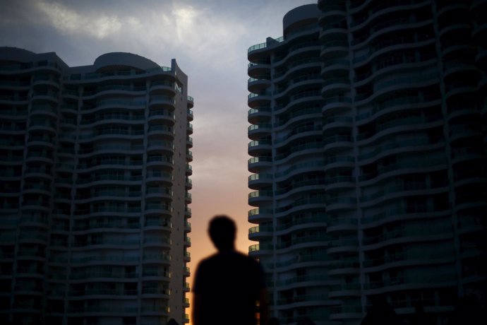 A man looks at sunset between buildings in Cancun