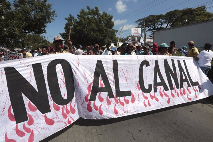 Demonstrators hold a banner during a protest march against the construction of t