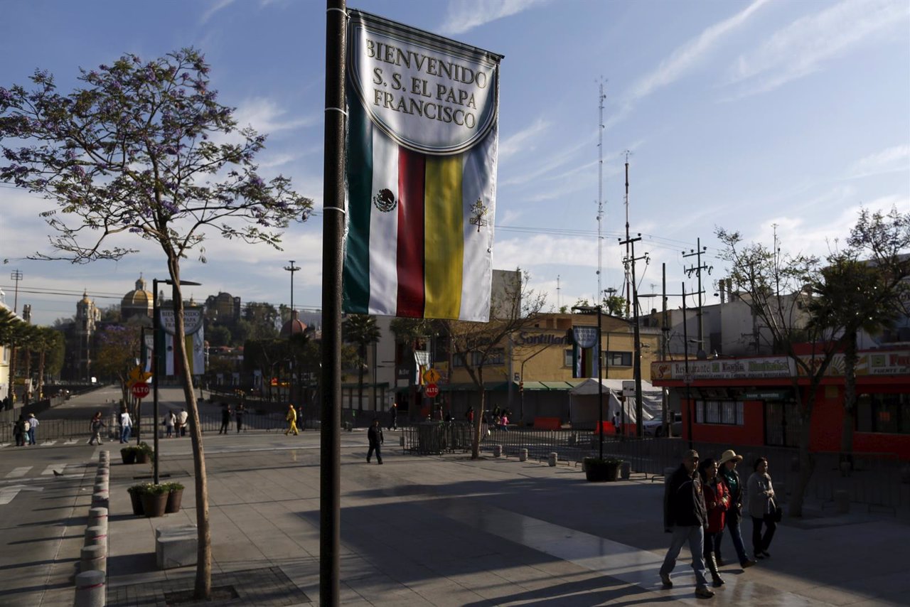 People walk past a banner near the Basilica of Guadalupe, ahead of the upcoming 