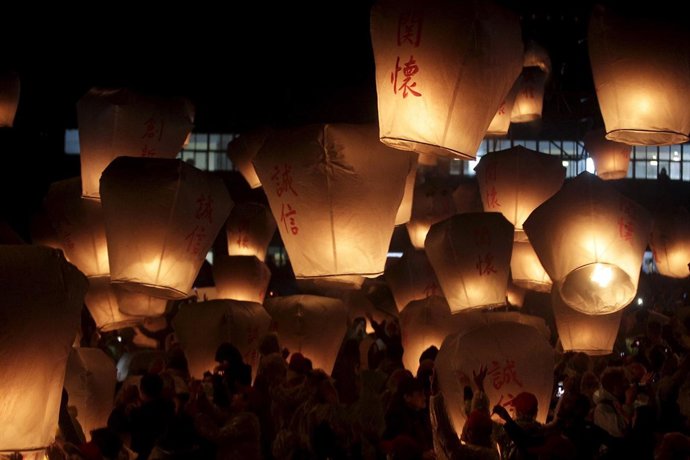 People release sky lanterns ahead of the traditional Chinese Lantern Festival in