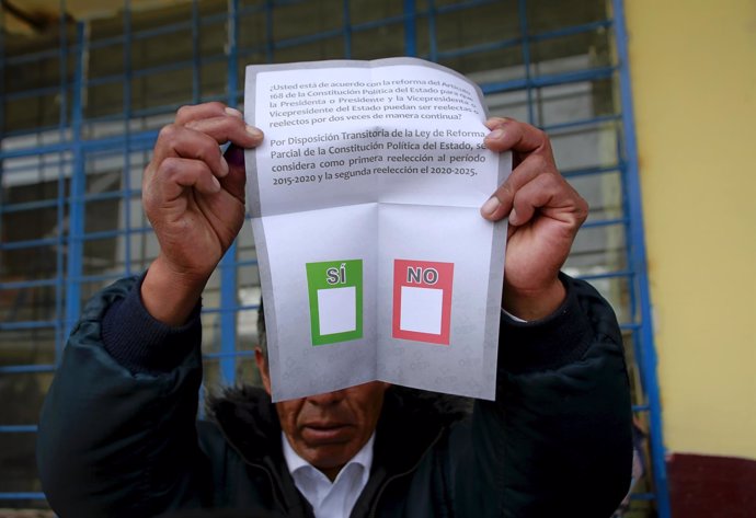 A member of the electoral polling committee holds a ballot paper during a nation
