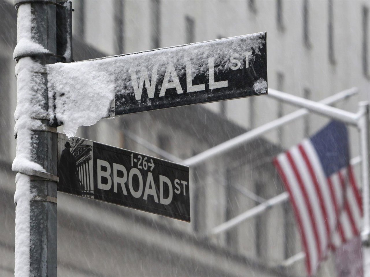 Snow covers a street sign at the corner of Wall St. And Broad St. In New York's 