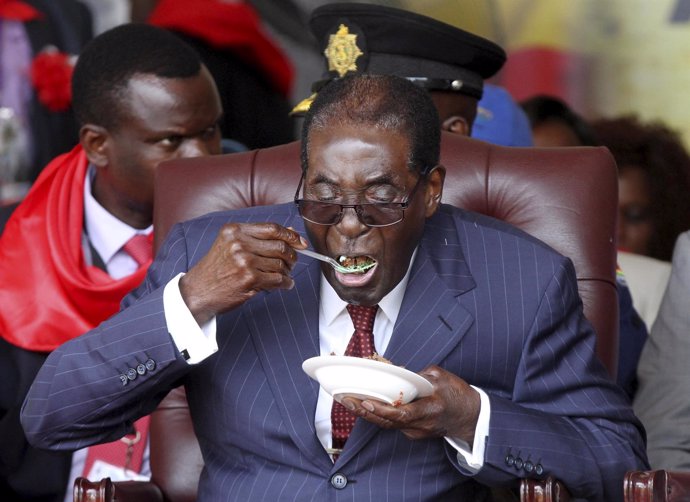 El presidente Mugabe come tarta en su cumpleaños