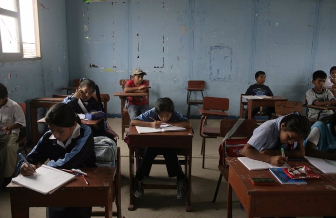 Students attend a class at a school in Pachacutec shanty town northern Lima