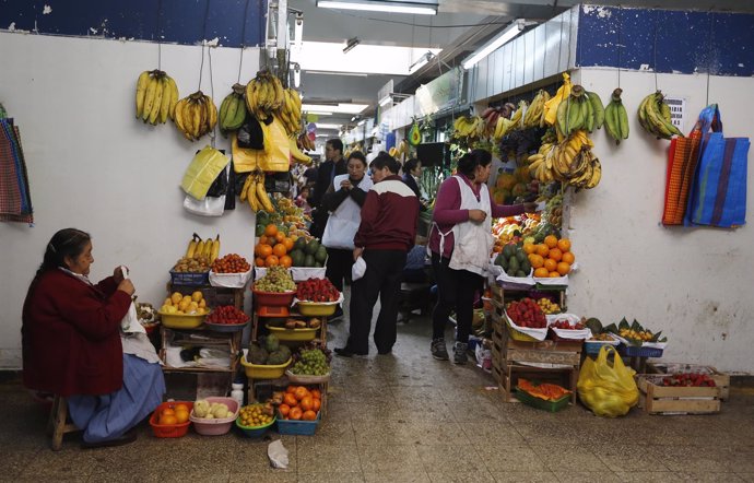 A woman sells fruit at the Central Market in downtown Lima