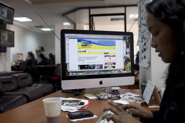 A journalist works in the office of the news site Noticias24.Com in Caracas