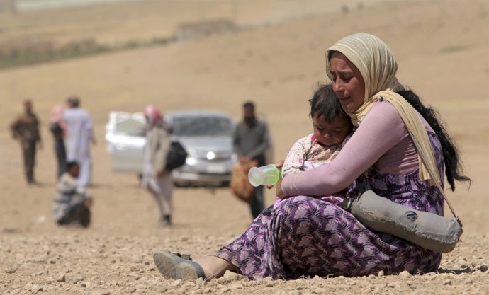 A displaced woman and child from minority Yazidi sect, fleeing violence from for