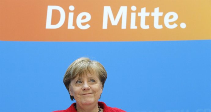 La canciller alemana, Angela Merkel, ante un cartel que dice "El Centro"