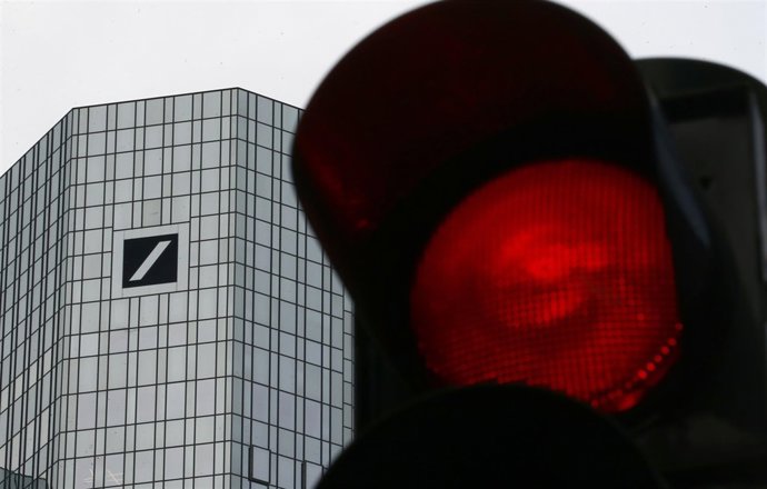 A red traffic lights is seen next to the headquarters of Germany's Deutsche Bank