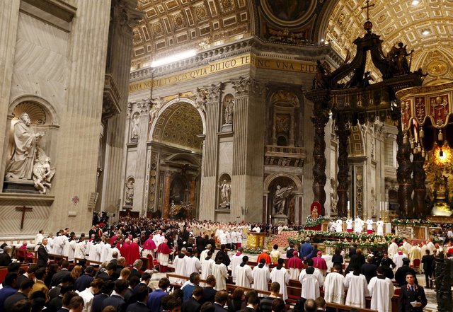 Pope Francis holds a candle as he leads the Easter vigil mass in Saint Peter's b