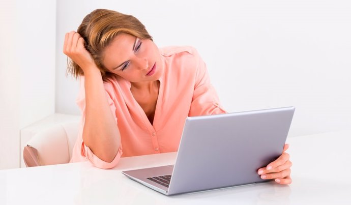Mujer enfrente de un ordenador con astenia primaveral