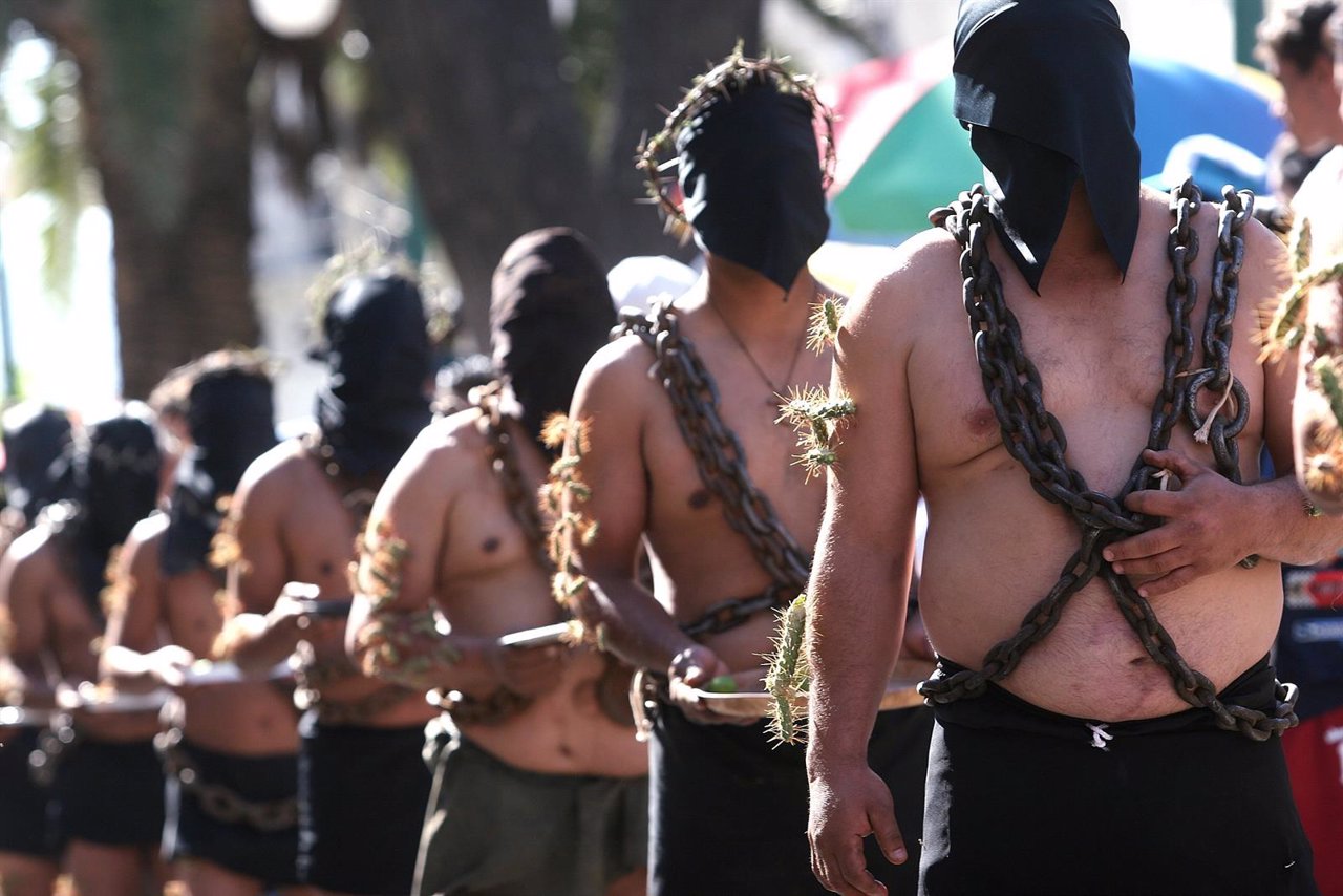 Mexican penitents, most of whom are migrants living in the U.S., wear chains and