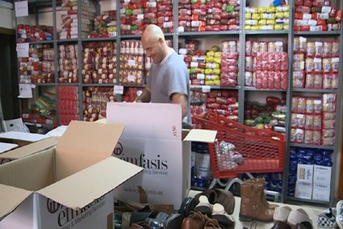 Un voluntario clasifica los alimentos donados
