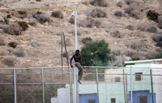 Un inmigrante africano intenta saltar la valla de Melilla
