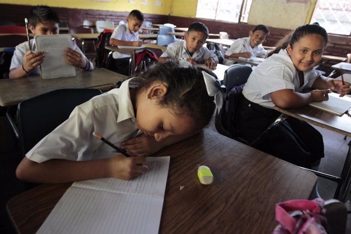 A student writes down in her note book on the first day of school in Managua