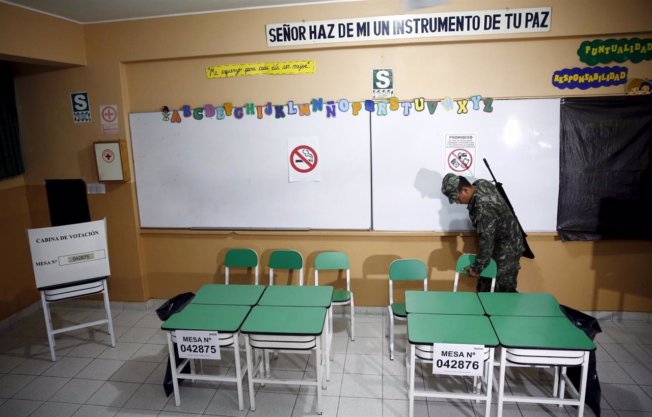 A soldier checks a polling station at a classroom before the start of the presid