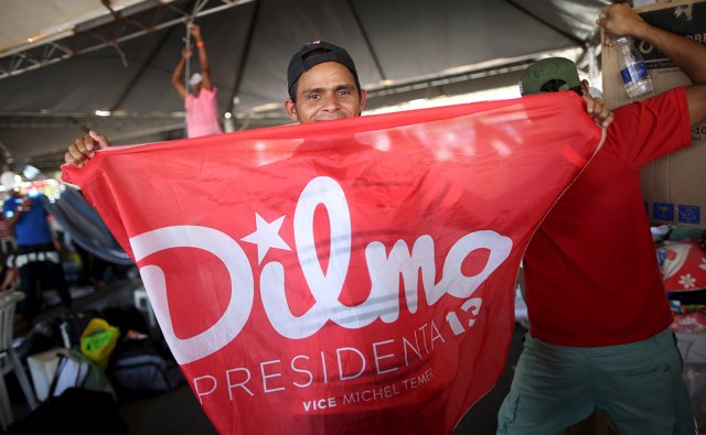 A member of the Landless Workers Movement (MST) shows a flag in support of Brazi