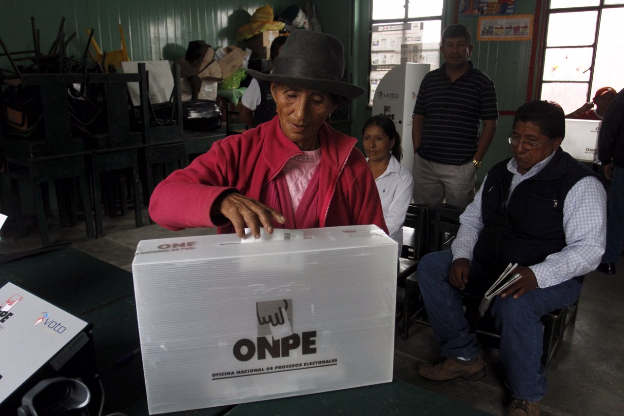 A woman casts her vote during presidential election at a polling station at a cl