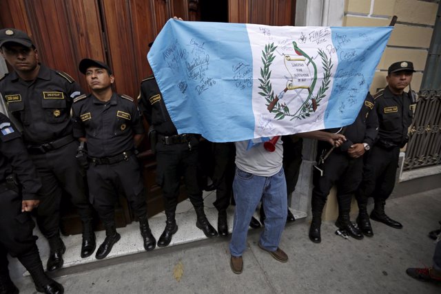 A man holds a Guatemala flag during a demonstration to celebrate the resignatio