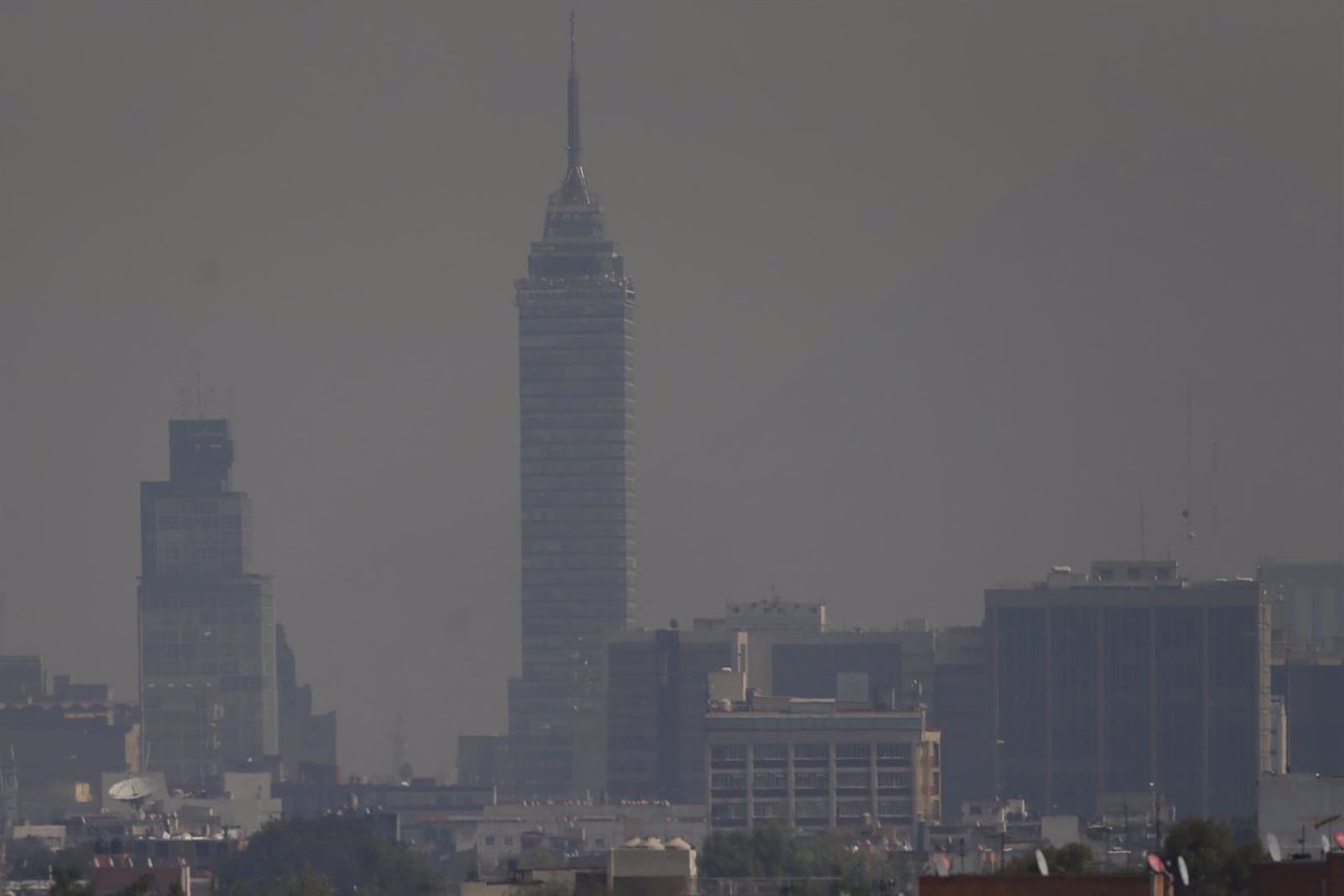 Buildings stand shrouded in smog in Mexico City