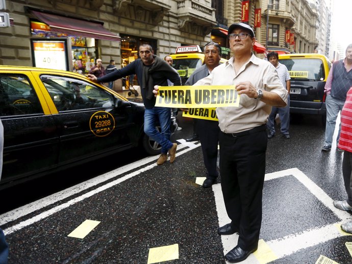 Taxi drivers block an avenue to protest against  Uber Technologies Inc. In downt