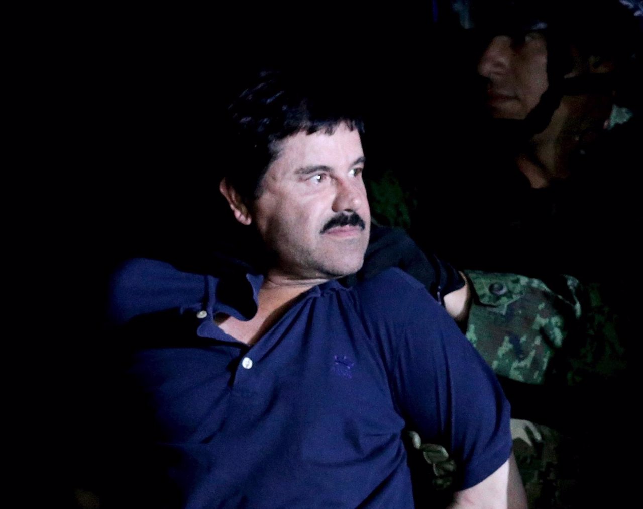 Recaptured drug lord Joaquin "El Chapo" Guzman is escorted by soldiers in Mexico