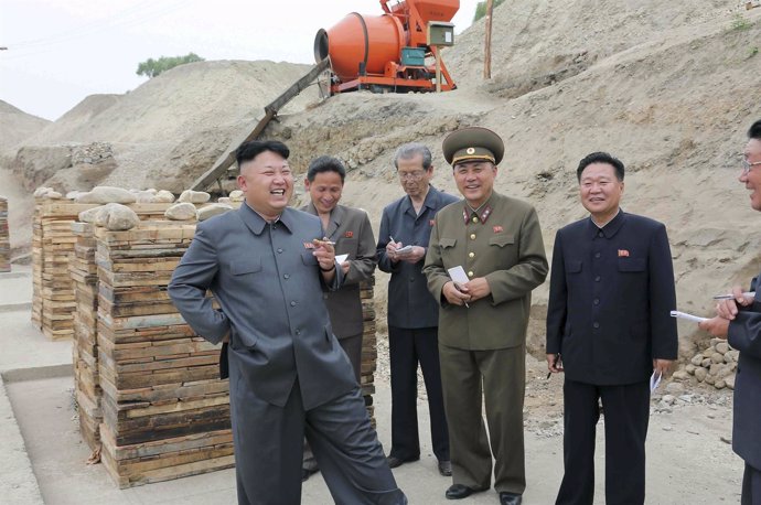 North Korean leader Kim Jong Un smokes a cigarette as he gives guidance on the d