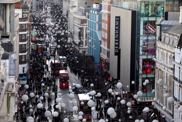 Shoppers and traffic travel along Oxford Street in London, Britain