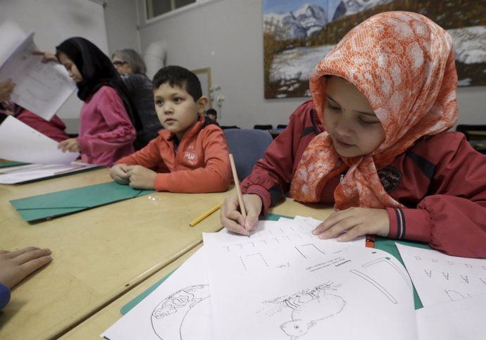 Refugee children attend class in a camp at a hotel touted as the world's most no