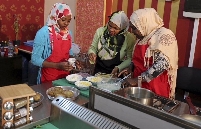 Women attend a cooking class conducted by Egyptian NGO Fard and Egyptian startup