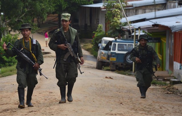 Guerrilleros de las FARC patrullan por un pueblo colombiano