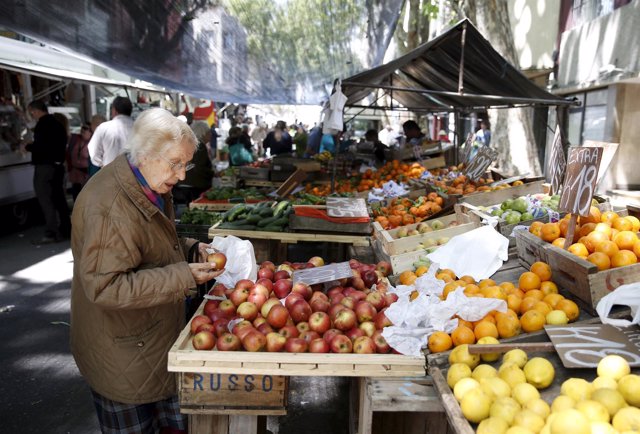 A woman buys fruits in a street market in downtown Montevideo