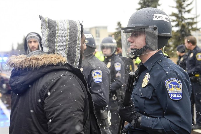 A member of the Black Lives Matter protesters argues with a police officer as th
