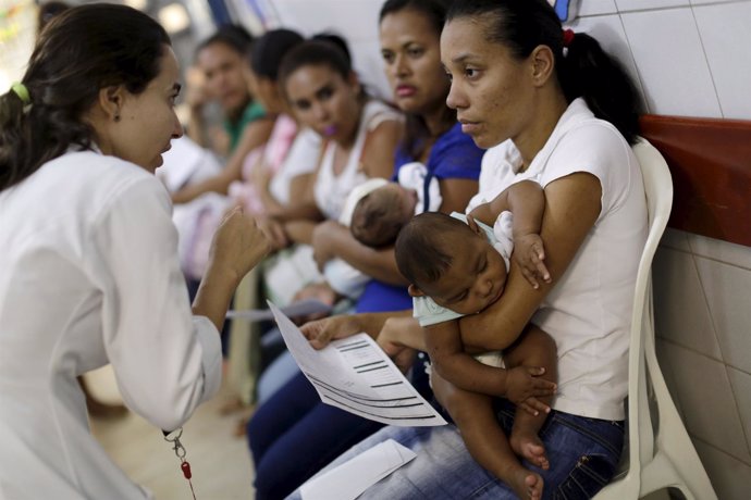 Mothers with their children, who have microcephaly, await medical care at the Ho