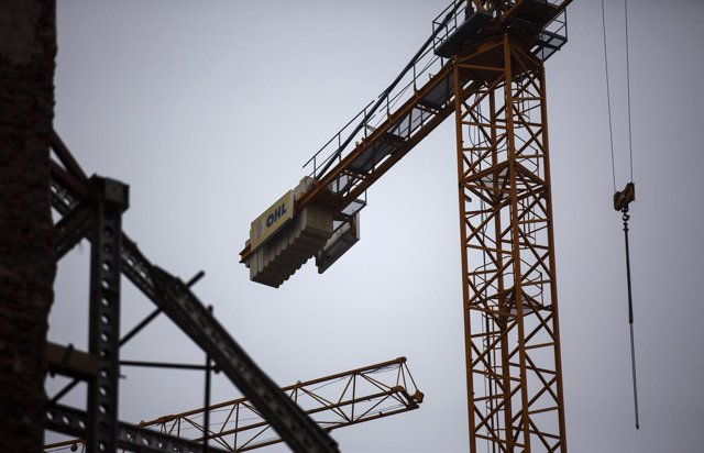 The logo of Spanish builder OHL on a crane at a construction site in Madrid