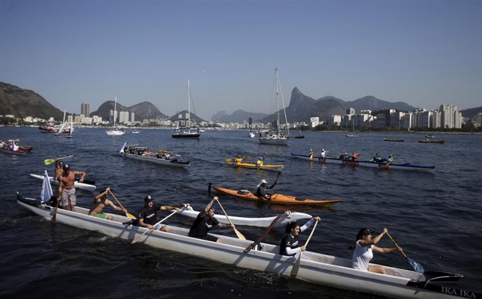 People navigate on their boats as they protest against the pollution 